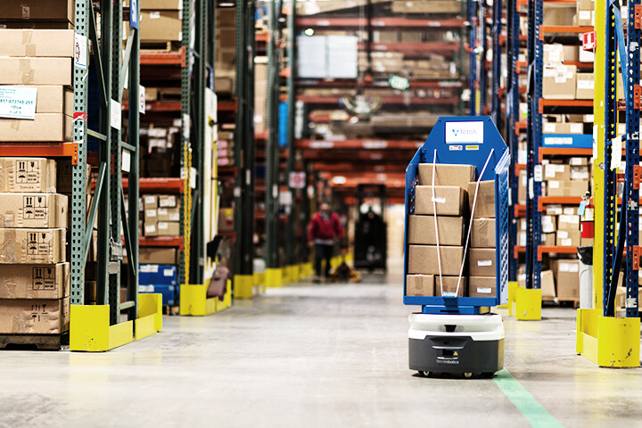 Robot moving boxes in warehouse